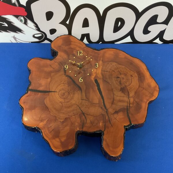 Vintage lacquered wood wall clock with natural wood grain.