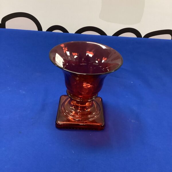 Stunning vintage red glass vase with a flared rim.