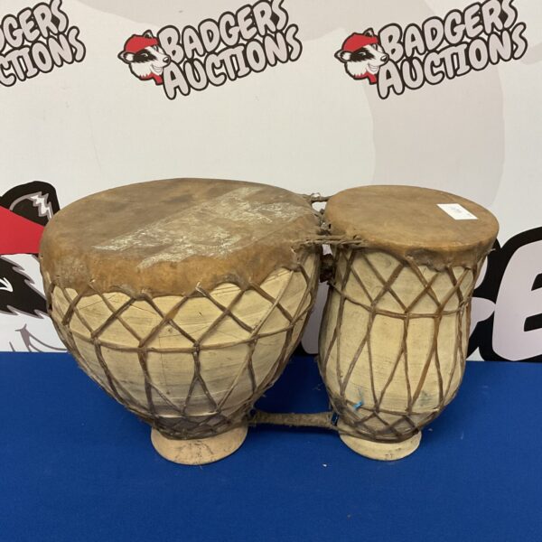 Vintage African bongos with painted details, traditional percussion instrument.