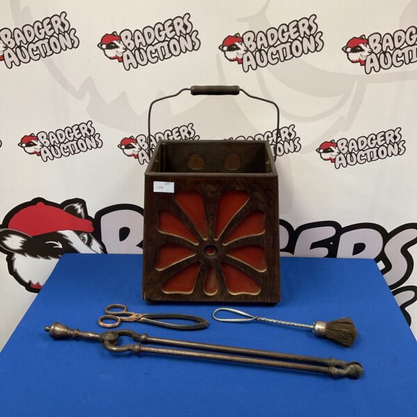 Vintage wooden speaker box holding fireplace tools, retro audio decor.
