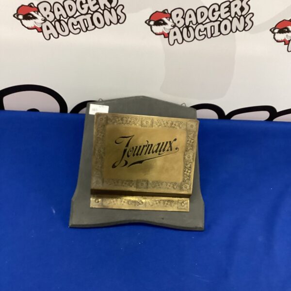 Vintage wooden newspaper holder with "Journaux" displayed on the front.