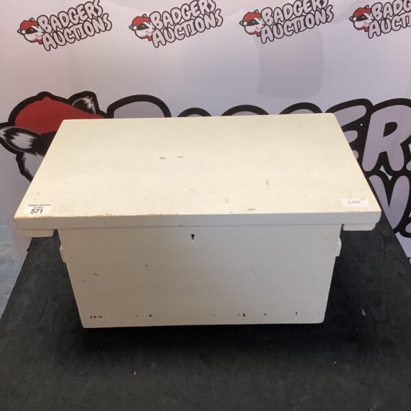 White wooden storage box with media cables inside.