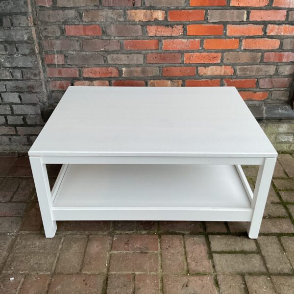 White IKEA coffee table with lower shelf, shabby chic style.