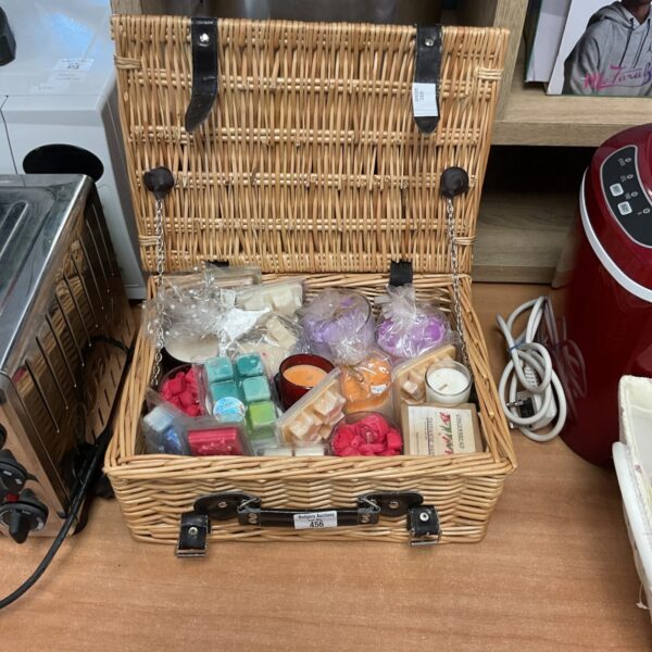 Wicker basket filled with scented candles and wax melts for home fragrance.