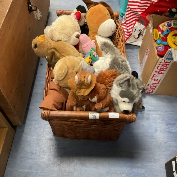 Wicker basket filled with vintage soft toys and teddies.