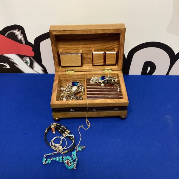 Vintage wooden jewellery box filled with jewellery and accessories.