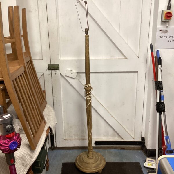 Vintage wooden standard lamp with a turned column and circular base.
