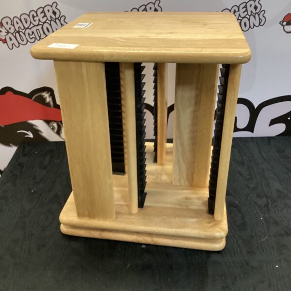 Vintage wooden swivel CD rack for media storage.