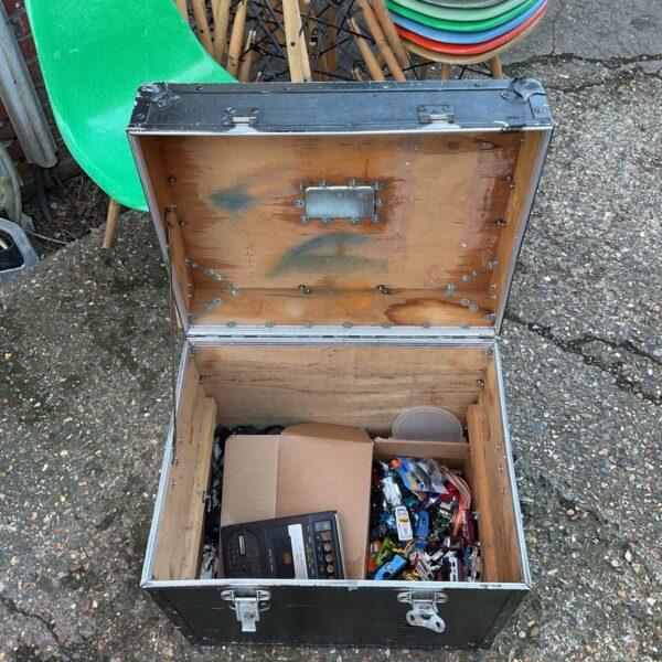 Vintage wooden trunk filled with diecast cars and collectibles.