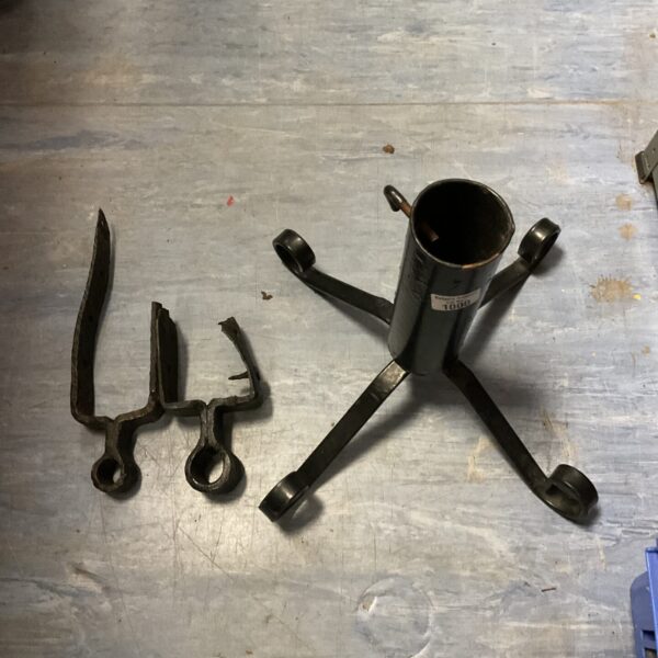 Antique wrought iron stand with sconce arm for vintage decor.
