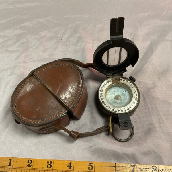 Vintage British military compass in leather pouch, WW2 era.