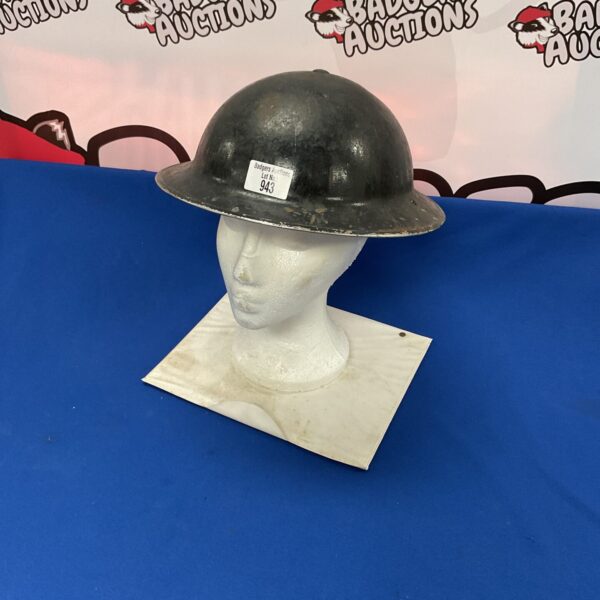 Vintage WW2 ARP warden helmet on display.