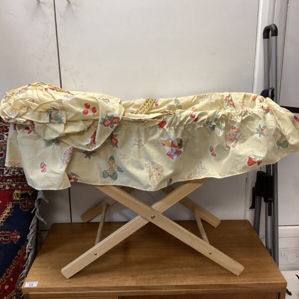 Vintage Zorbit Moses basket with patterned lining and wooden stand.