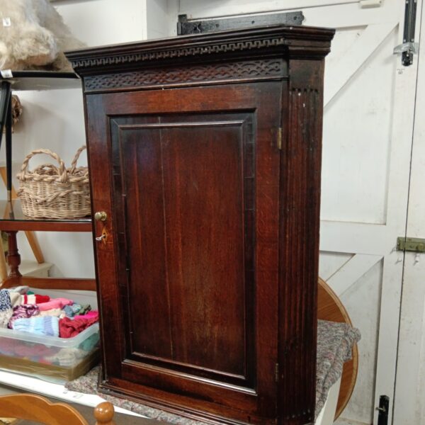 Antique Georgian corner cabinet in mahogany, showcasing classic design.