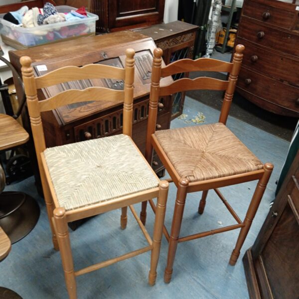 Vintage beech bar stools with woven rattan seats for kitchen use.