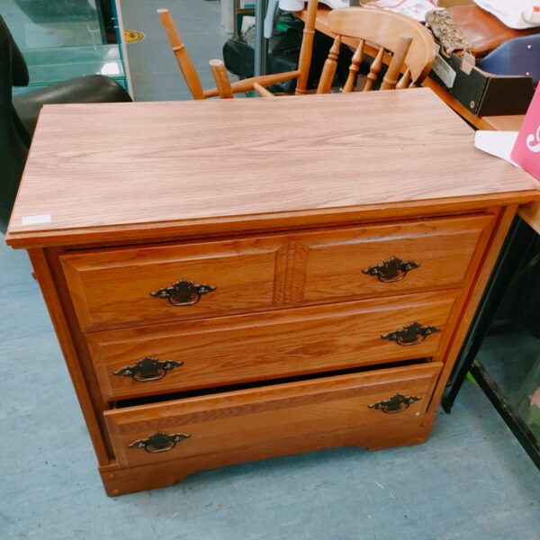 Vintage oak chest of drawers with two over two configuration.