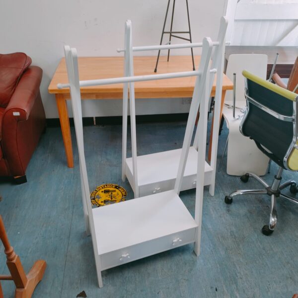Pair of vintage wooden childrens clothes rails in a playroom setting.