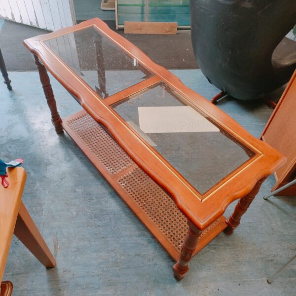 Vintage glass top coffee table with wooden frame.