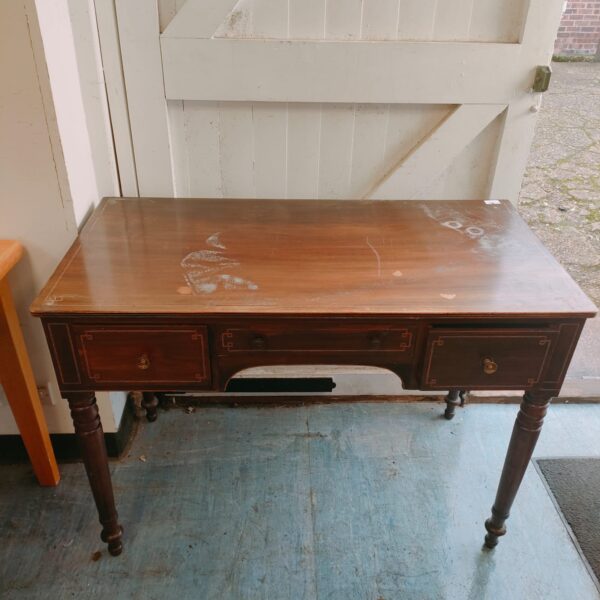 Vintage mahogany desk with two drawers and inlaid pattern.