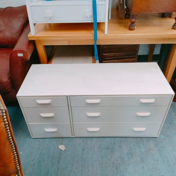 White six-drawer cabinet for bedroom or office storage.