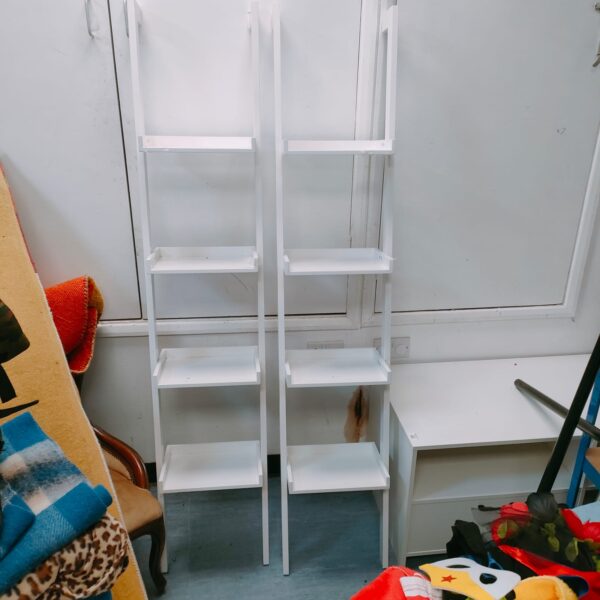 Pair of white wooden hanging book shelves for display.
