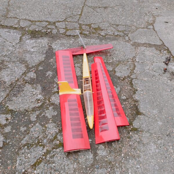 Vintage red and yellow balsa wood RC glider plane model.