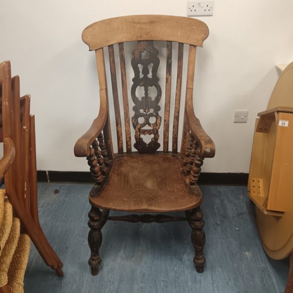 Antique lathe back Windsor chair with armrests, front view.