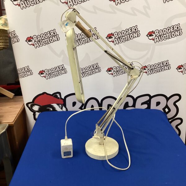 Vintage Anglepoise lamp with adjustable arm and circular base.
