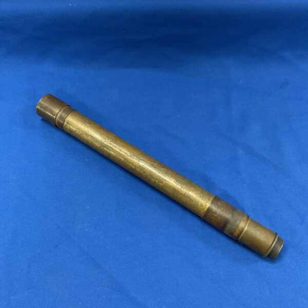 Antique brass two-drawer telescope on a blue background.