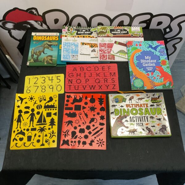 Collection of dinosaur books and stencils for children's educational play.
