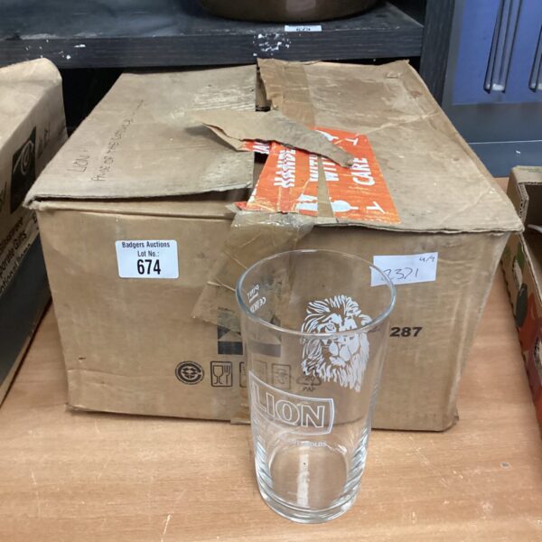 Box of eight Lion Pride of the Cotswolds pint glasses.