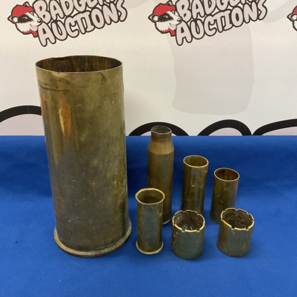 Vintage brass shell cases displaying trench art detailing.