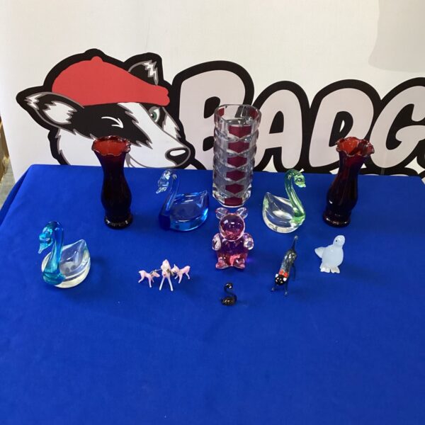Colourful collection of glass swan ornaments for home decor.