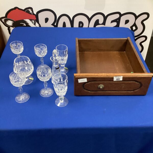 Vintage crystal glasses displayed in a drawer, elegant glassware collection.