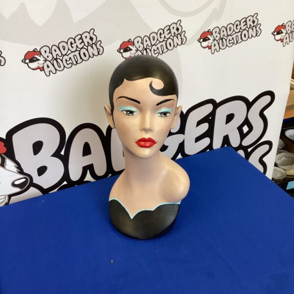 Female fibreglass mannequin head for wig and accessory display.