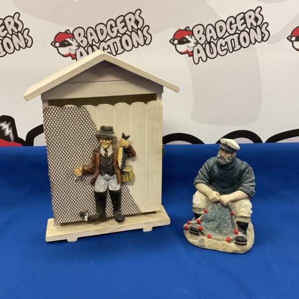 Detailed fisherman key box and resin sea captain sculpture for nautical decor.
