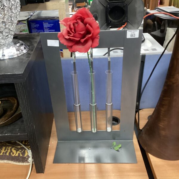 Vintage floral display stand with tiered flower holders.