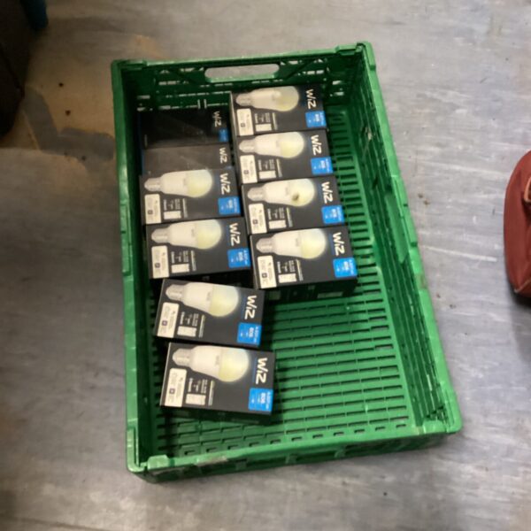 Tray of Wiz smart light bulbs and remotes for home automation.