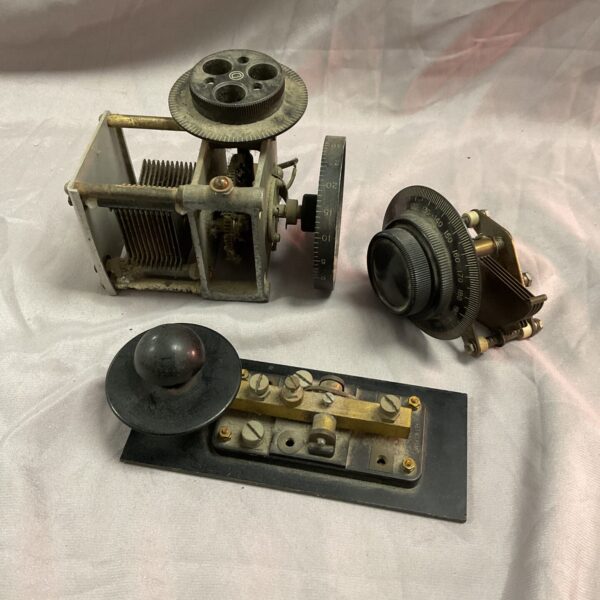 Vintage radio tuner and morse key, antique communication equipment.