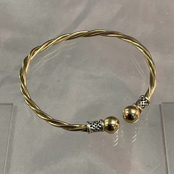 Gold and silver twisted metal bracelet, unique jewellery design.