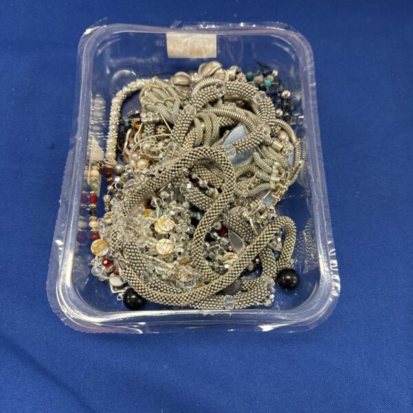 Tray of vintage costume jewellery with necklaces and brooches.