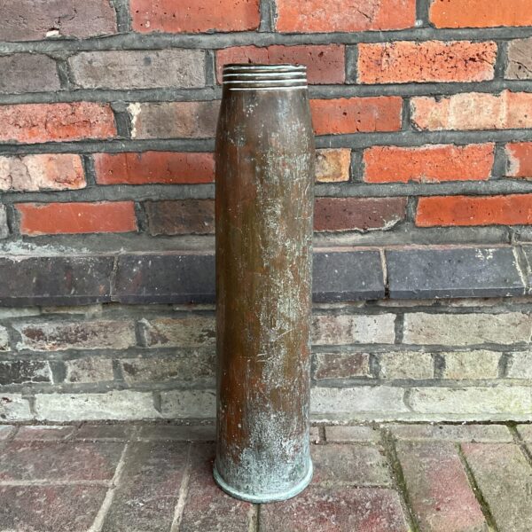 Antique WWI naval shell casing made of copper.
