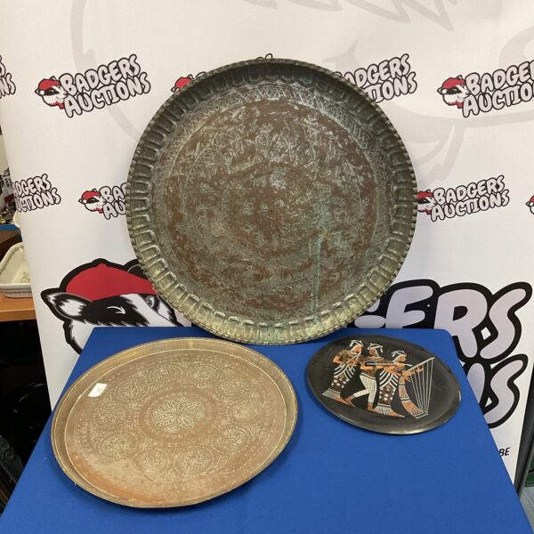 Large Indian copper charger with intricate embossed detailing.