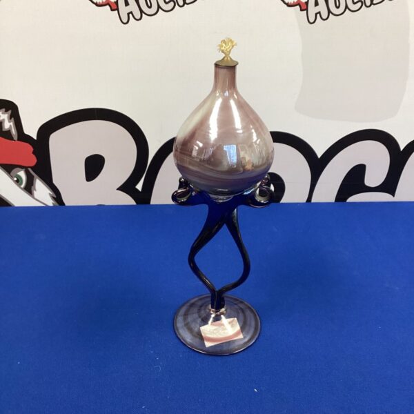 Vibrant purple handmade glass oil lamp with metal stand.