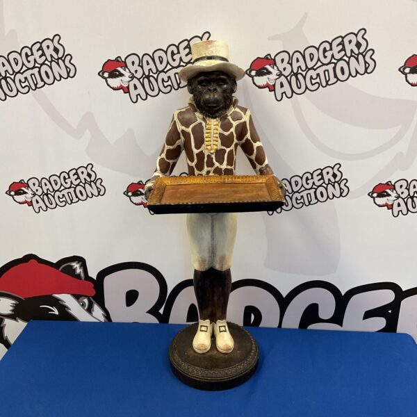 Vintage wooden monkey butler holding a tray.