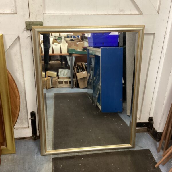 Large gold framed wall mirror for home decor.