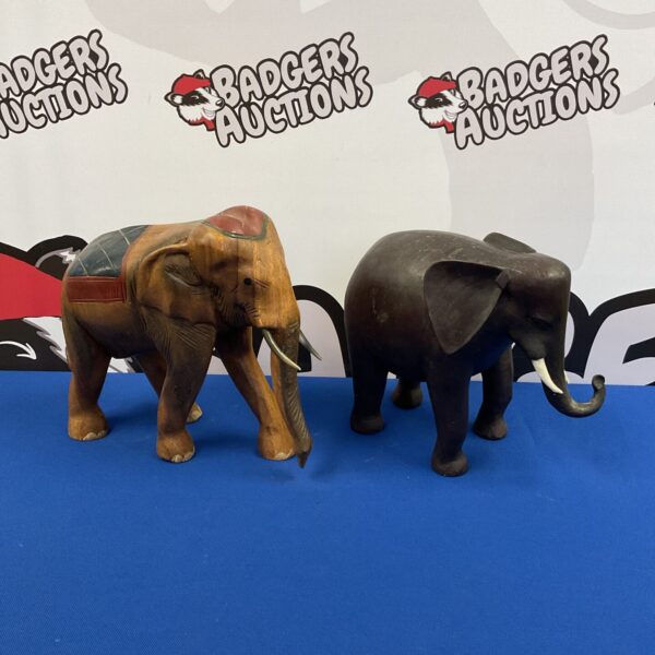 Pair of vintage carved wooden elephants on display.