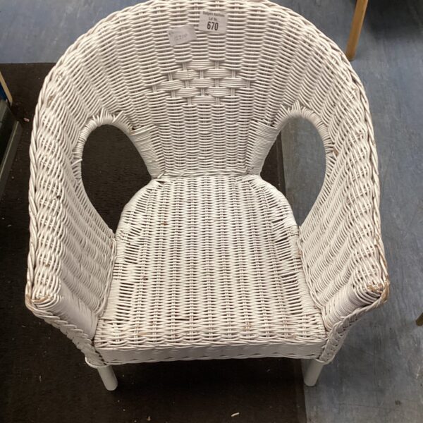Vintage child's wicker chair for nursery or doll display.