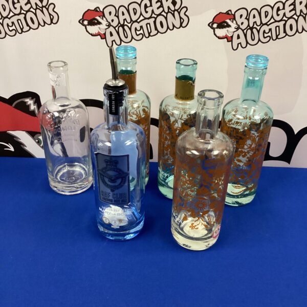 Selection of empty vintage gin bottles for display.