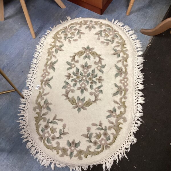 Vintage Indian oval rug with a floral pattern.